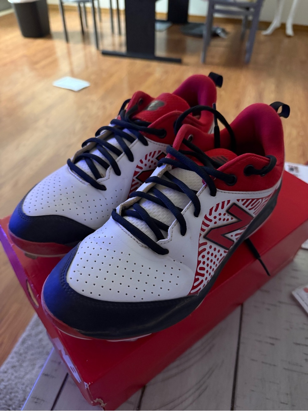 New Balance Women’s black, red and white softball cleats